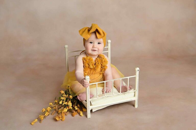 Photo of toddler on brass bed prop for milestone session image by Dallas / Fort Worth Maternity, Newborn, and Children's Photographer Chaunva LeCompte Photography